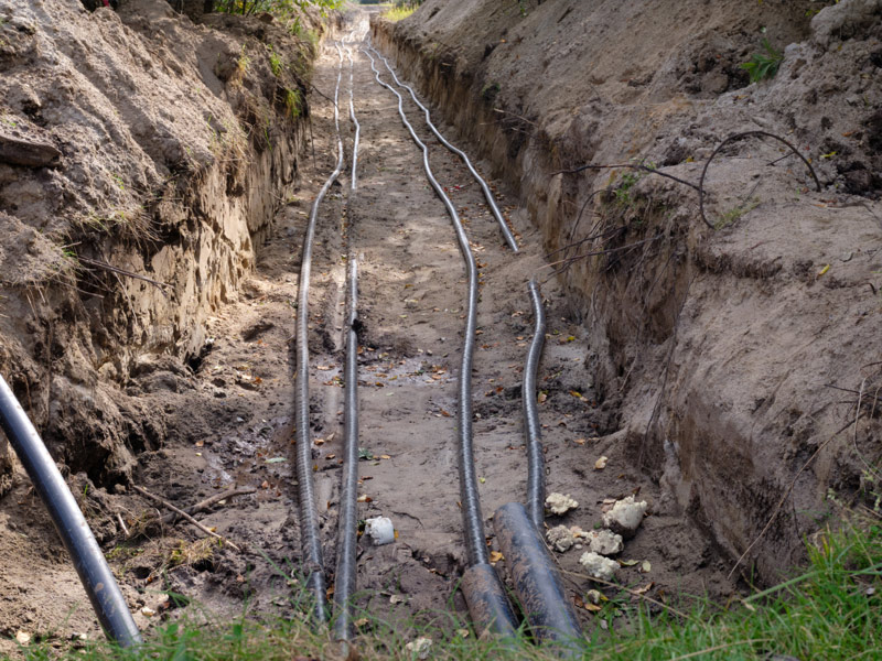 Utility trench with conduit runs for a private property service installation