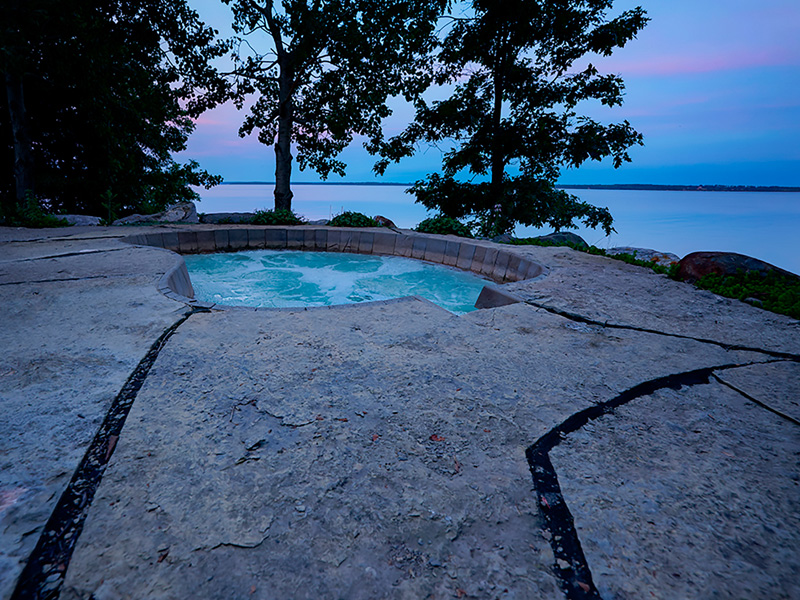 Waterfront home exterior with finished landscape